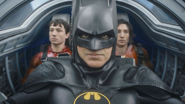 This image released by Warner Bros. Pictures shows Ezra Miller, from left, Michael Keaton and Ezra Miller in a scene from "The Flash." (Warner Bros. Pictures via AP)
